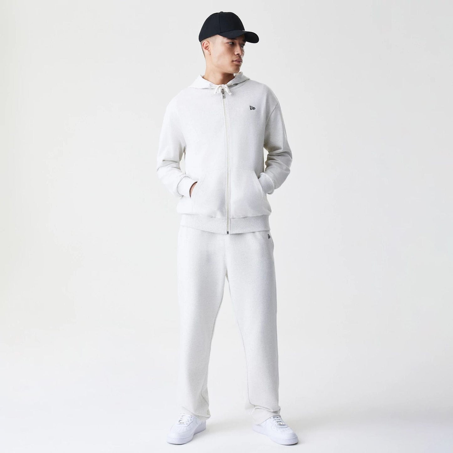 The Male model is wearing New Era Premium Essential Pastel Grey Oversized Full Zip Hoodie 8