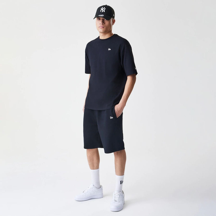 The Male model is wearing New Era Premium Essential Black Oversized Shorts 8