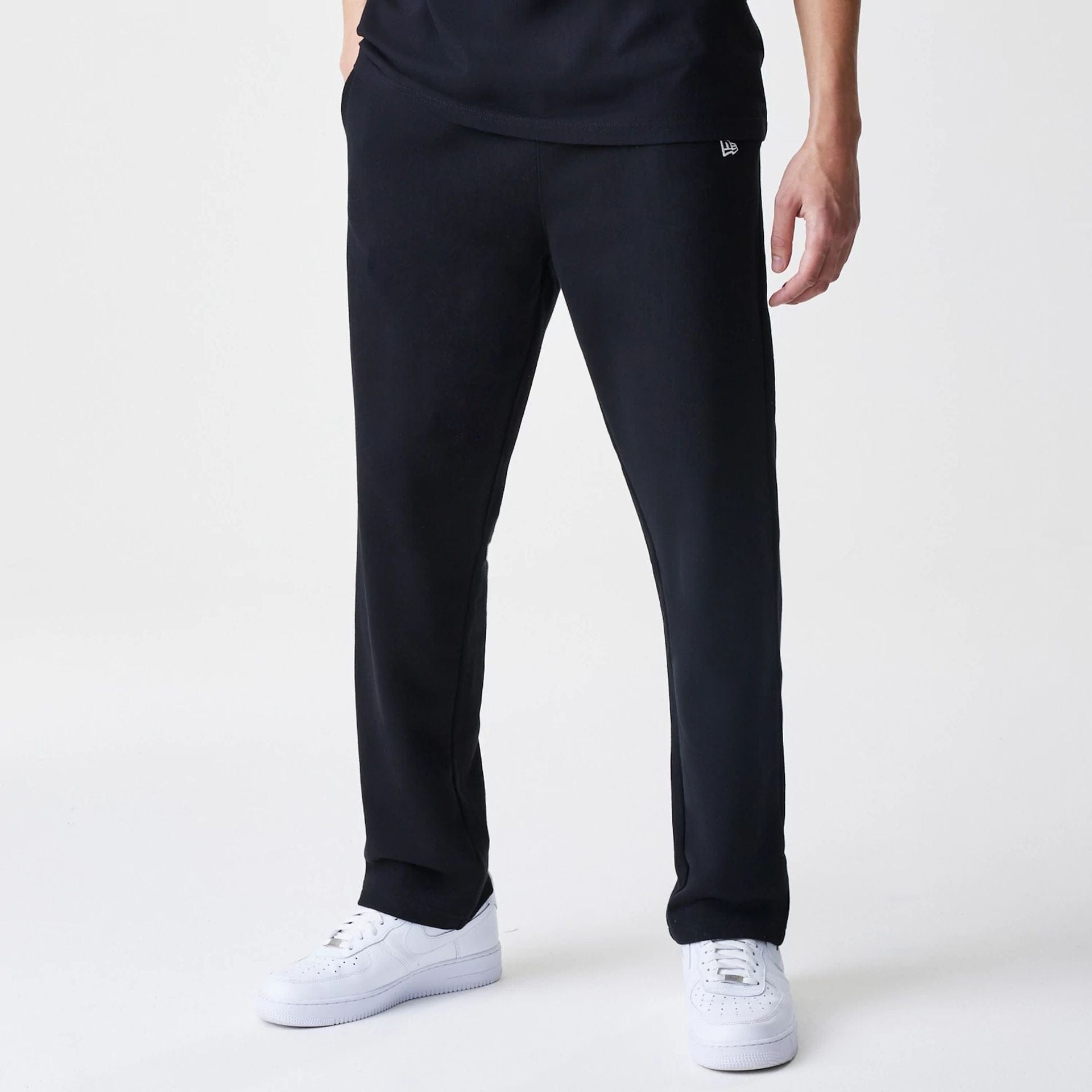 The Male model is wearing New Era Premium Essential Black Joggers 1