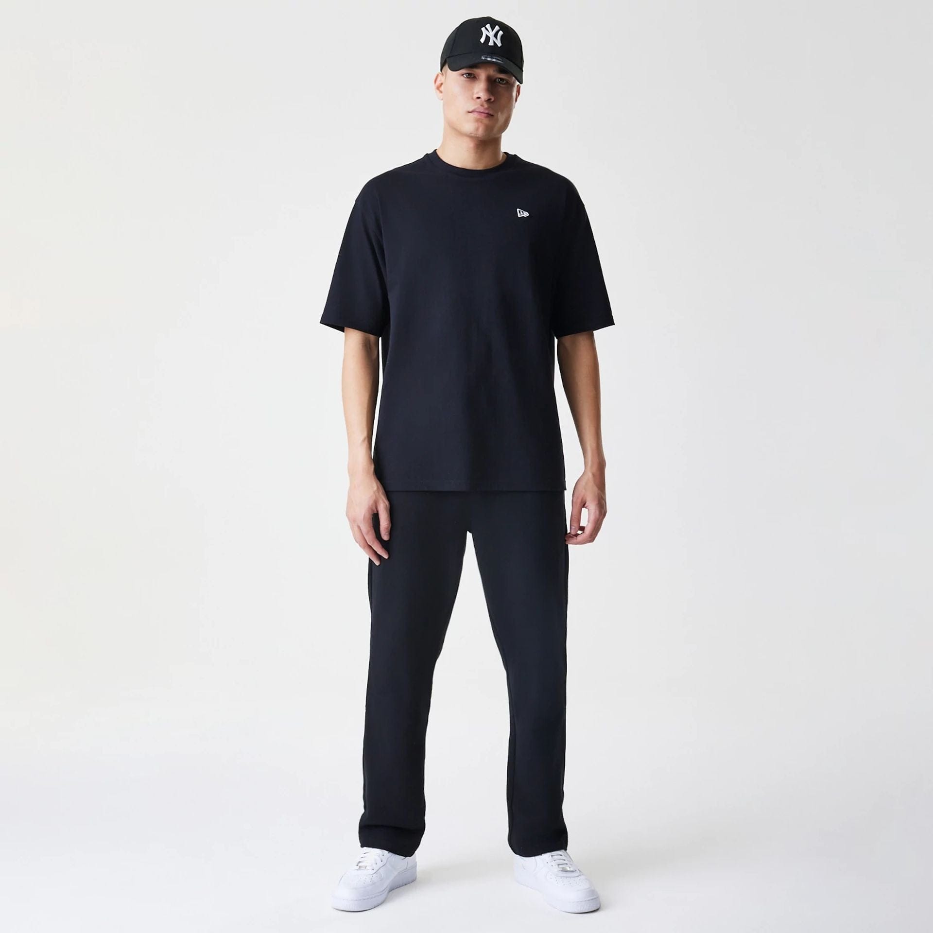 The Male model is wearing New Era Premium Essential Black Joggers 8