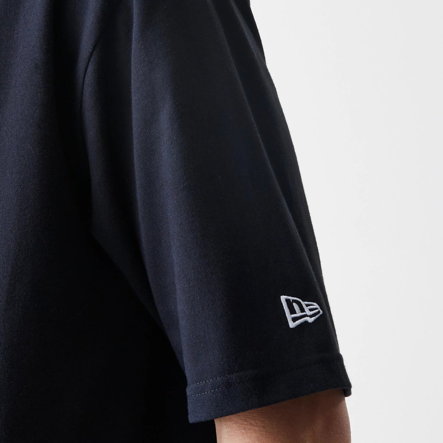 The Male model is wearing New Era Premium Essential Black Oversized T-Shirt 5