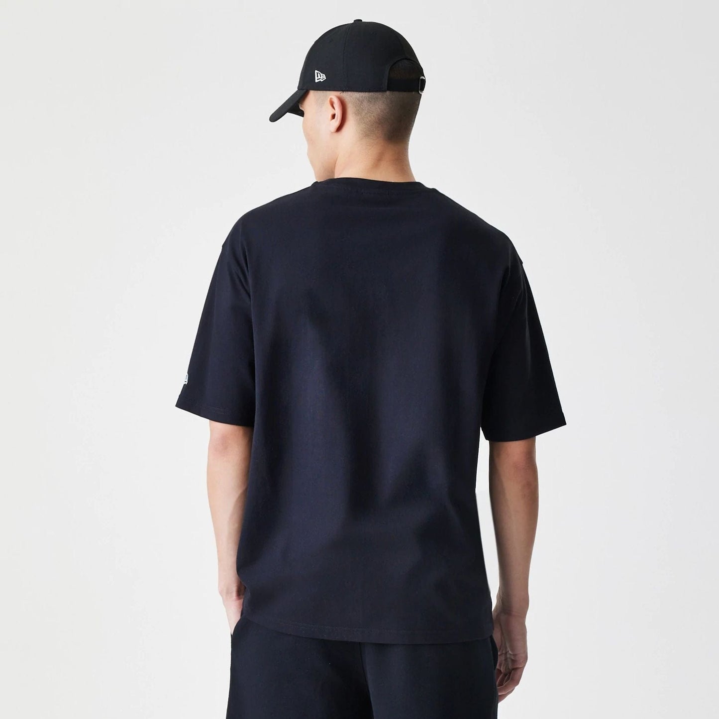 The Male model is wearing New Era Premium Essential Black Oversized T-Shirt 2