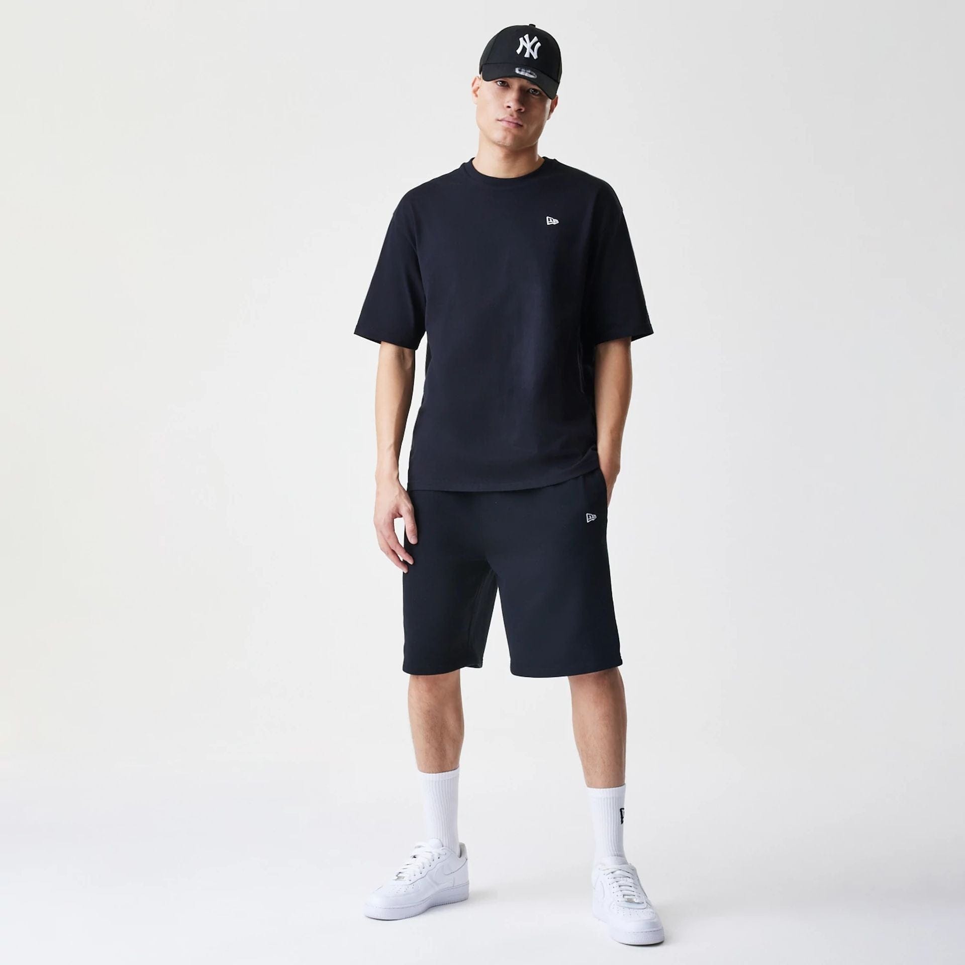 The Male model is wearing New Era Premium Essential Black Oversized T-Shirt 8