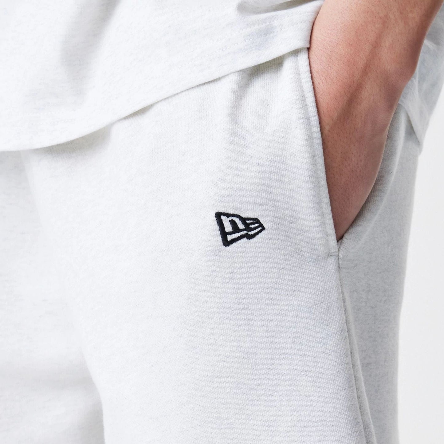 The Male model is wearing New Era Premium Essential Pastel Grey Oversized Shorts 5