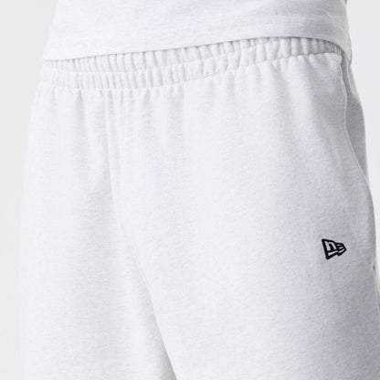 The Male model is wearing New Era Premium Essential Pastel Grey Oversized Shorts 6