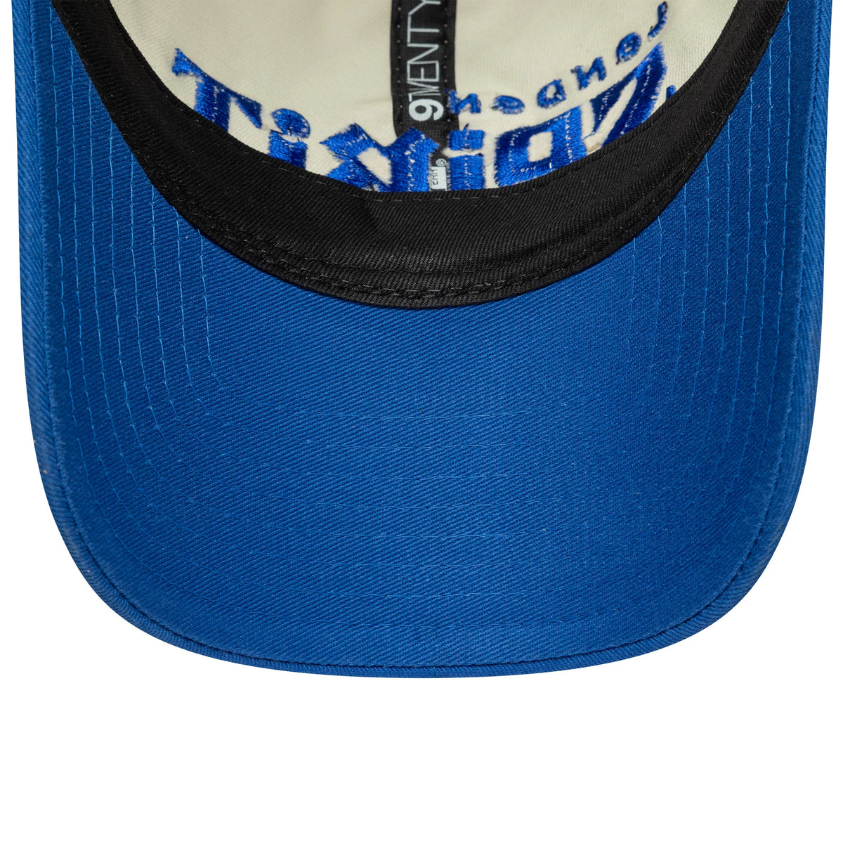 London Spirit The Hundred 2025 Contrast Light Beige New Era 9TWENTY Adjustable Cap, inside view showing the black sweatband, cream undervisor, blue embroidered details on the crown interior, and New Era branded taping running across the panels.