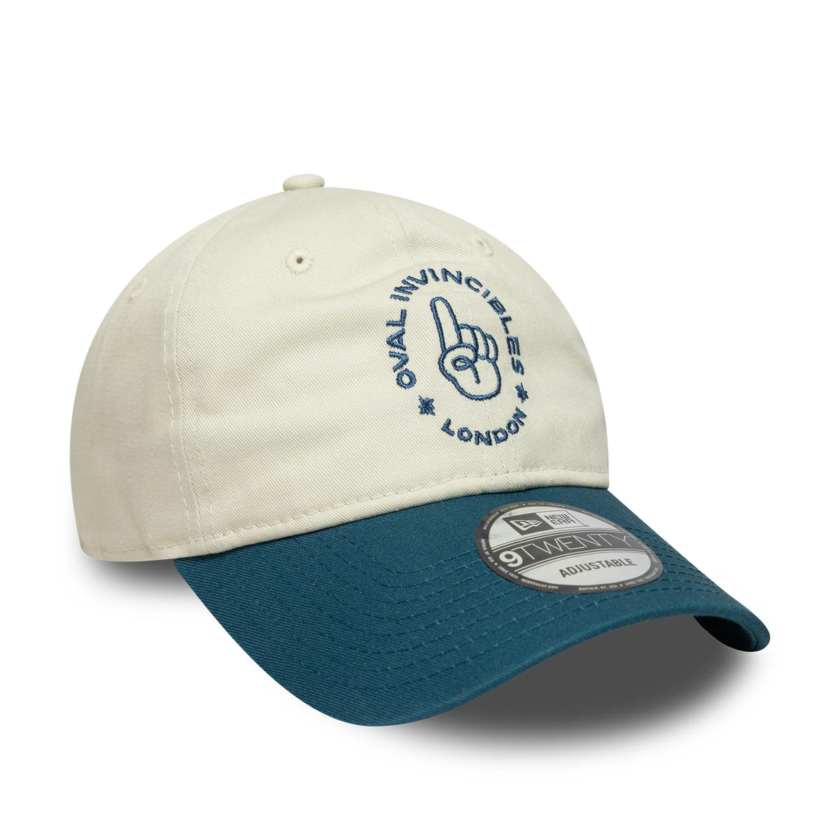 Oval Invincibles The Hundred 2025 Contrast Light Beige New Era 9TWENTY Adjustable Cap, three-quarter view showing the navy embroidered logo on the front panel, contrasted with the dark turquoise curved visor and 9TWENTY size sticker.