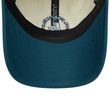 Oval Invincibles The Hundred 2025 Contrast Light Beige New Era 9TWENTY Adjustable Cap, inside view showing a black sweatband, light beige lining, and a teal undervisor with detailed black stitching and a logo print near the sweatband.
