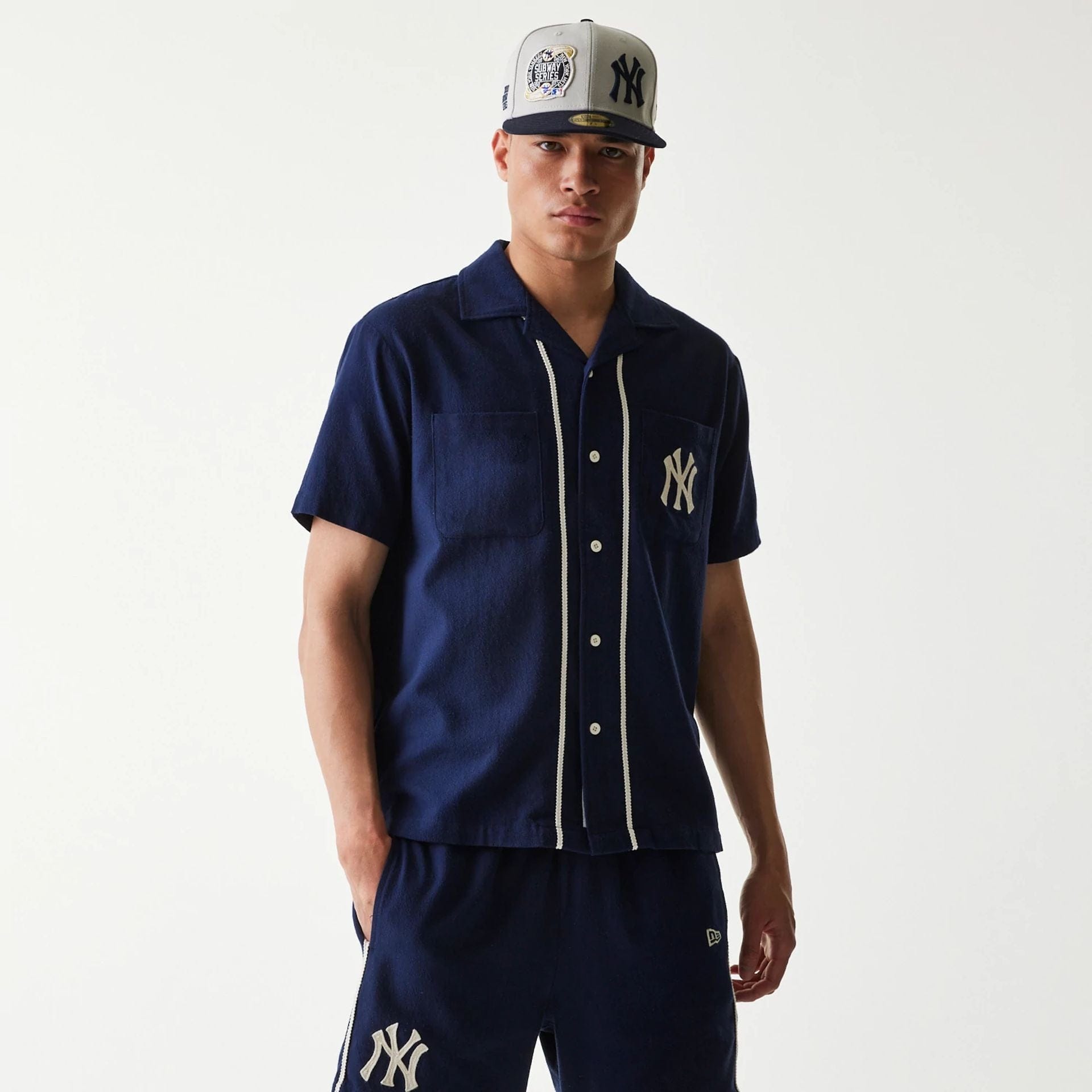 The Male model is wearing New York Yankees MLB Piping Navy Short Sleeve Shirt 1