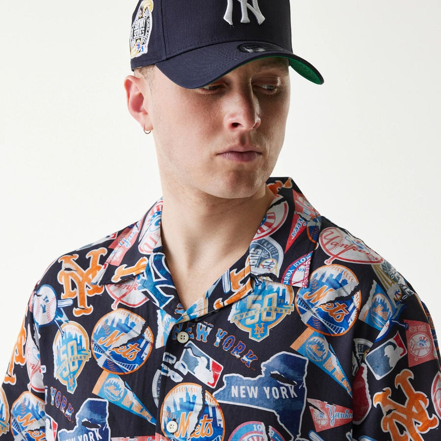 The Male model is wearing MLB Subway Series All Over Print Navy Short Sleeve Shirt 6