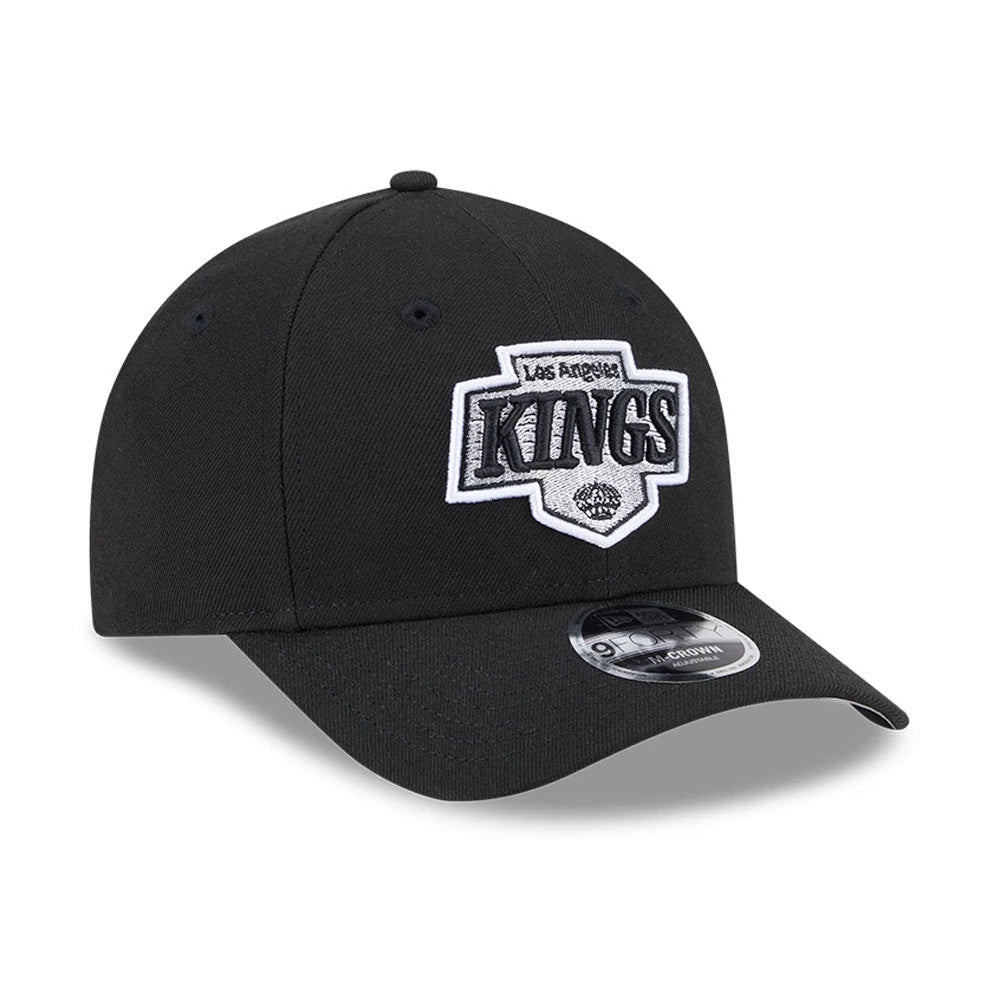 LA Kings NHL Team Black New Era 9FORTY M-Crown Adjustable Cap, front view showing the raised white and silver embroidered LA Kings logo on the front panels, with black visor and attached 9FORTY size sticker.