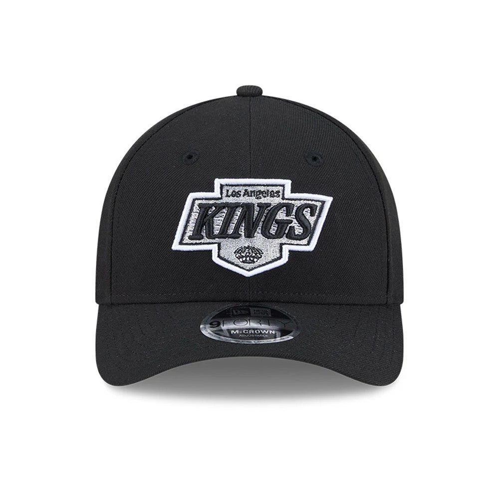 LA Kings NHL Team Black New Era 9FORTY M-Crown Adjustable Cap, front view showing the raised white and silver embroidered LA Kings logo on the structured black crown, with a 9FORTY size sticker on the curved black visor.
