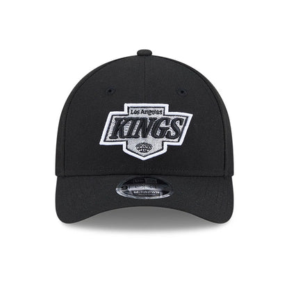 LA Kings NHL Team Black New Era 9FORTY M-Crown Adjustable Cap, front view showing the raised white and silver embroidered LA Kings logo on the structured black crown, with a 9FORTY size sticker on the curved black visor.