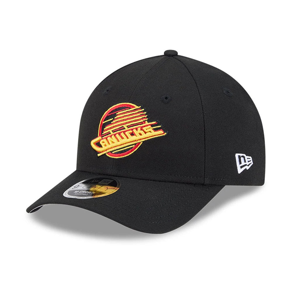 Vancouver Canucks NHL Team Black New Era 9FORTY M-Crown Adjustable Cap, three-quarter view with raised yellow and red Canucks logo embroidered on the front panel, curved black visor and grey undervisor, and white New Era flag logo on the left side.