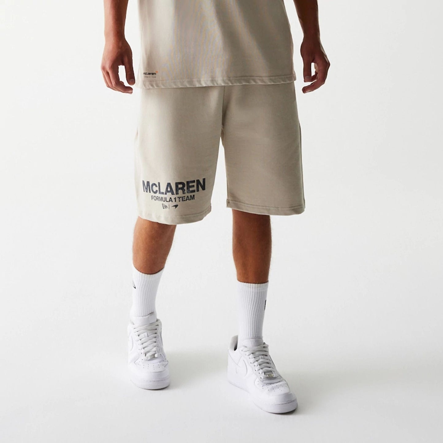 The Male model is wearing McLaren Racing Wordmark Light Beige Oversized Shorts 7