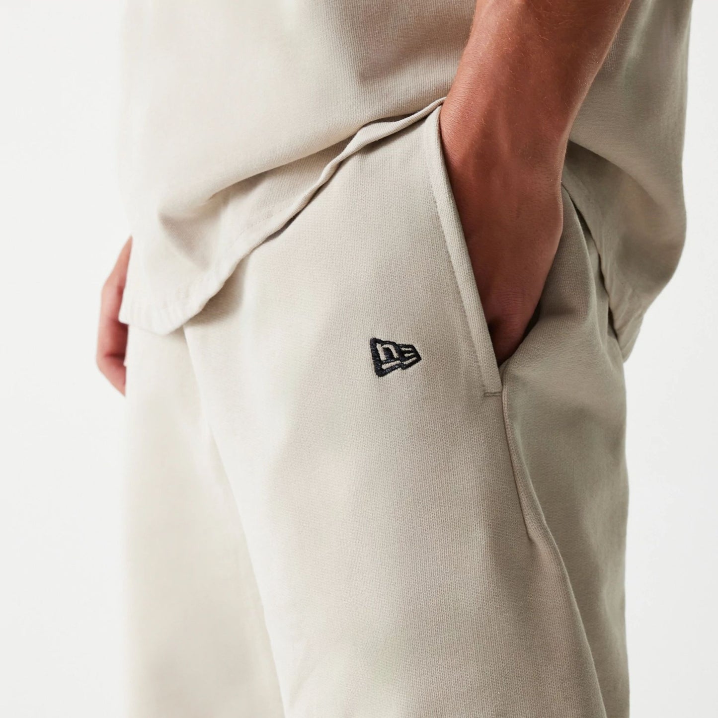 The Male model is wearing McLaren Racing Wordmark Light Beige Oversized Shorts 4
