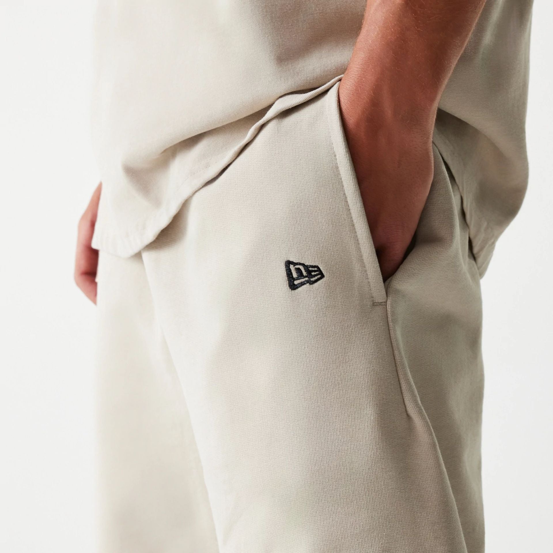 The Male model is wearing McLaren Racing Wordmark Light Beige Oversized Shorts 4