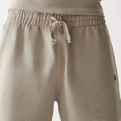 The Male model is wearing McLaren Racing Wordmark Light Beige Oversized Shorts 5
