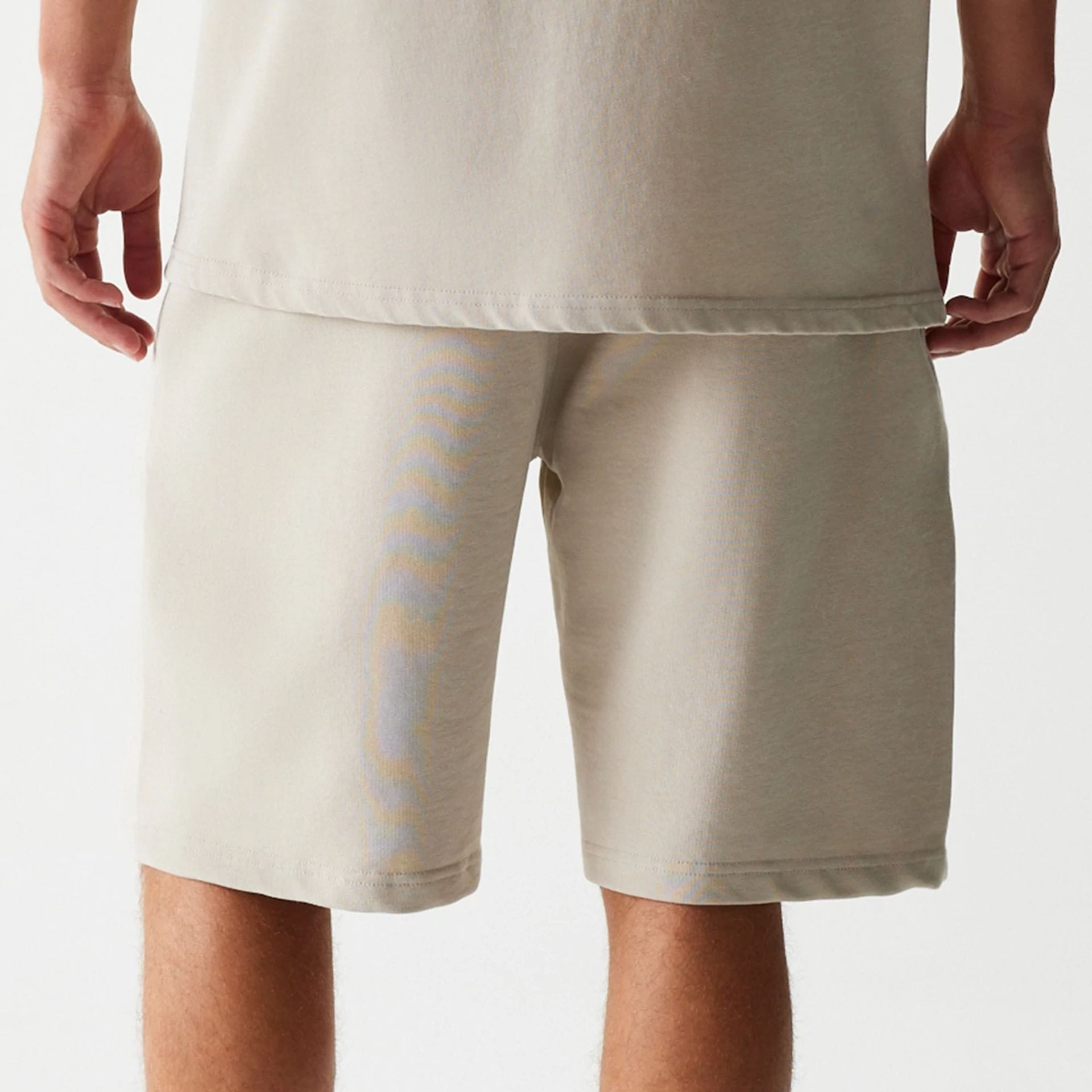 The Male model is wearing McLaren Racing Wordmark Light Beige Oversized Shorts 6