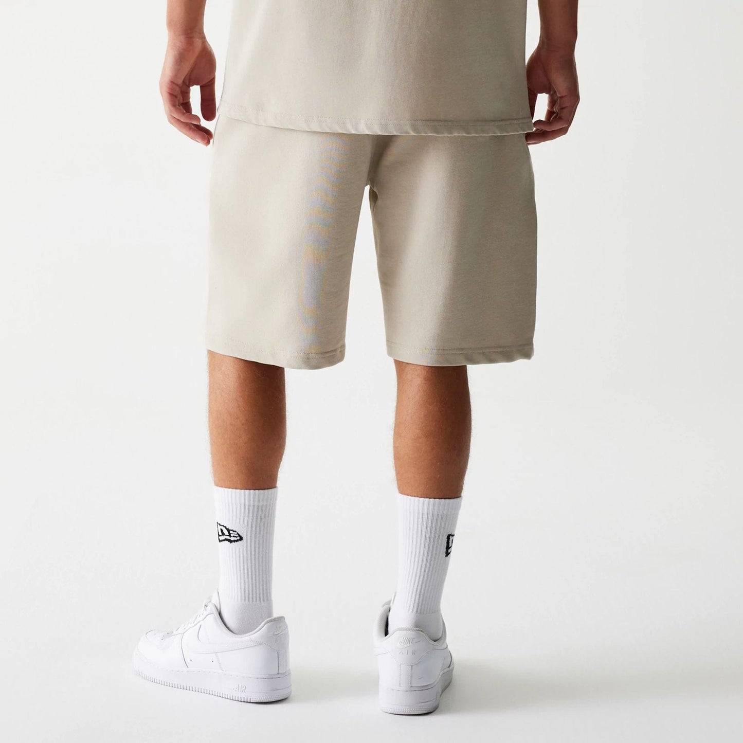 The Male model is wearing McLaren Racing Wordmark Light Beige Oversized Shorts 2