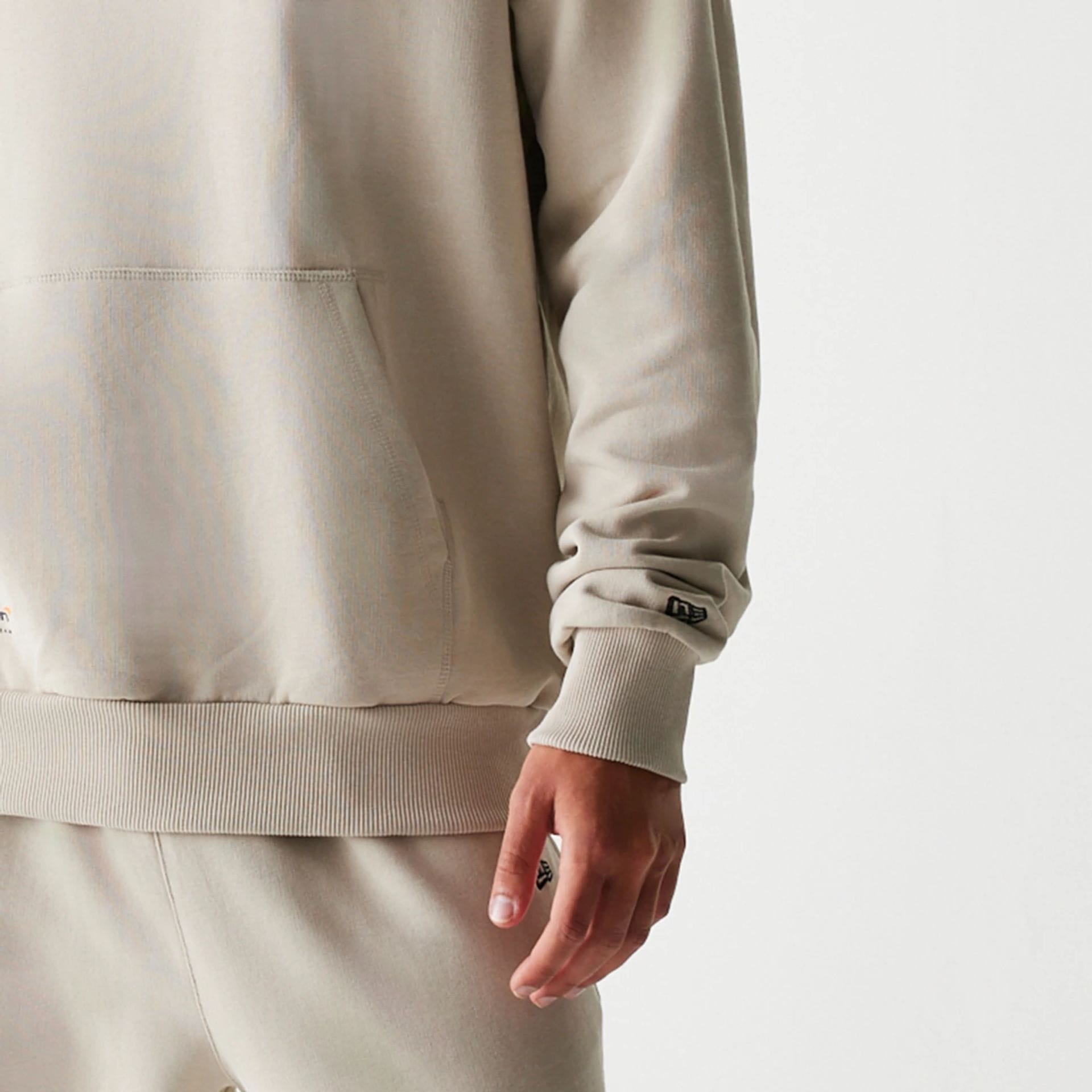 The Male model is wearing McLaren Racing Wordmark Light Beige Oversized Pullover Hoodie 4