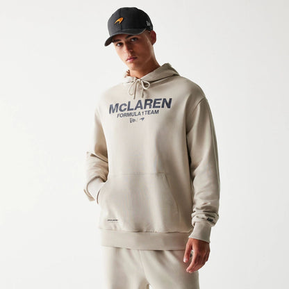 The Male model is wearing McLaren Racing Wordmark Light Beige Oversized Pullover Hoodie 1