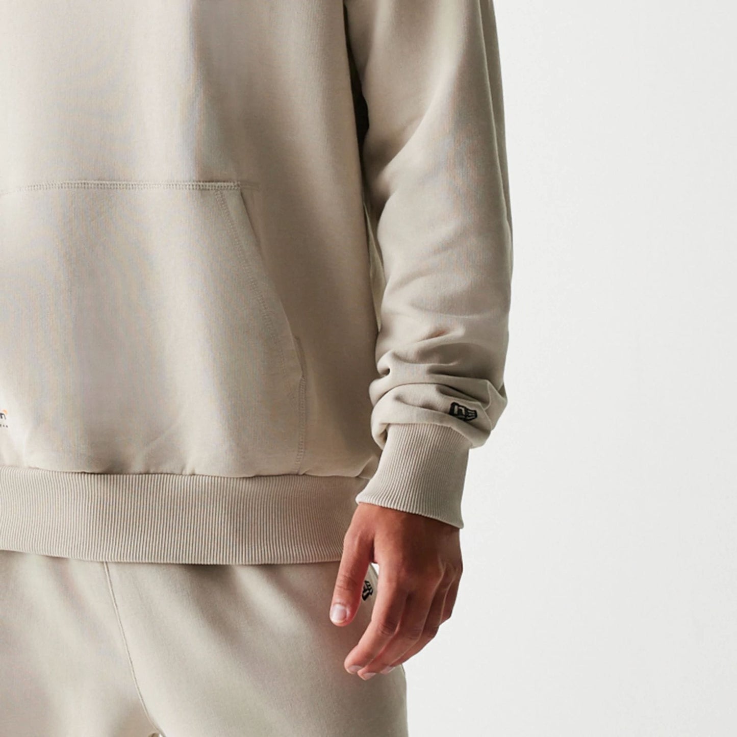 The Male model is wearing McLaren Racing Wordmark Light Beige Oversized Pullover Hoodie 4