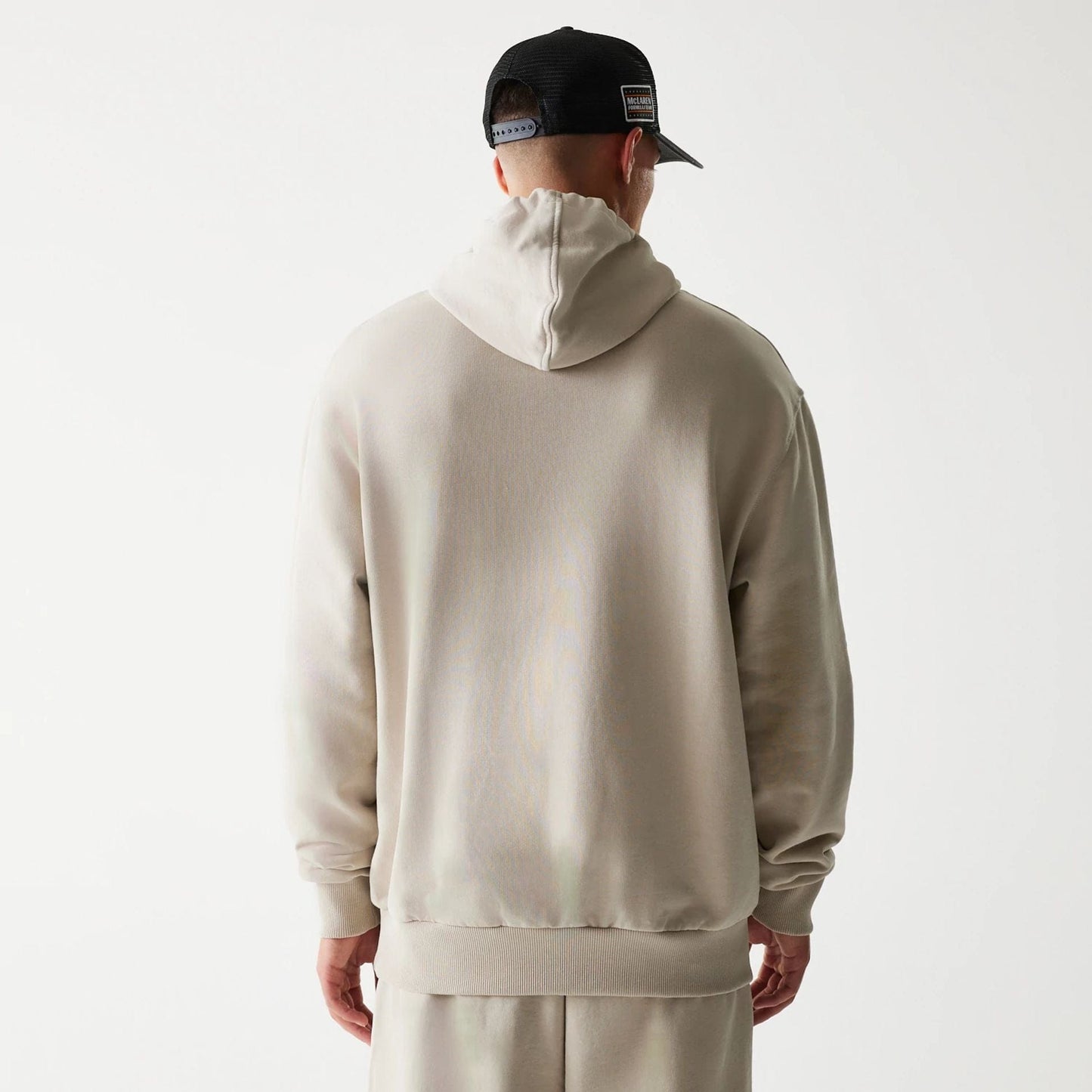 The Male model is wearing McLaren Racing Wordmark Light Beige Oversized Pullover Hoodie 2