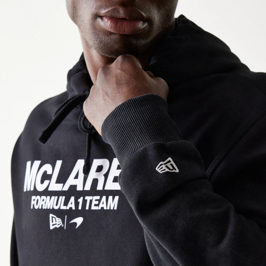 The Male model is wearing McLaren Racing Wordmark Black Oversized Pullover Hoodie 4