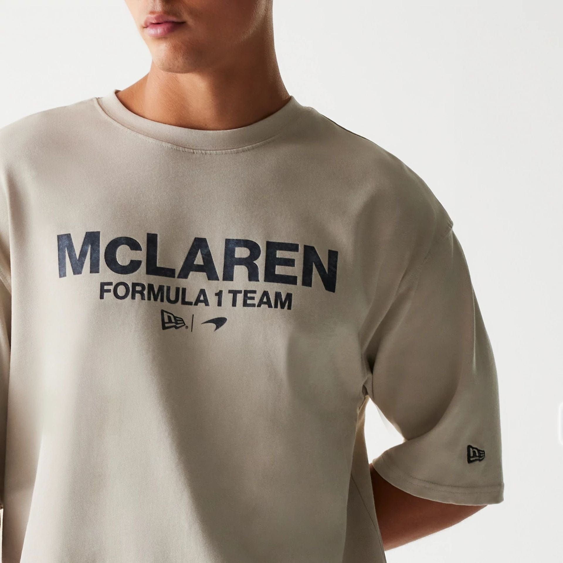 The Male model is wearing McLaren Racing Wordmark Light Beige Oversized T-Shirt 3