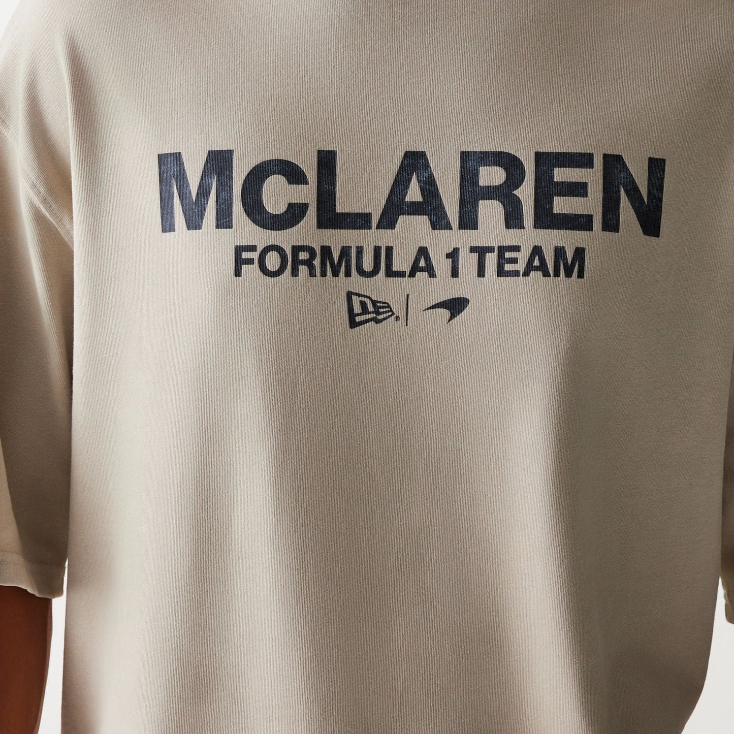 The Male model is wearing McLaren Racing Wordmark Light Beige Oversized T-Shirt 4