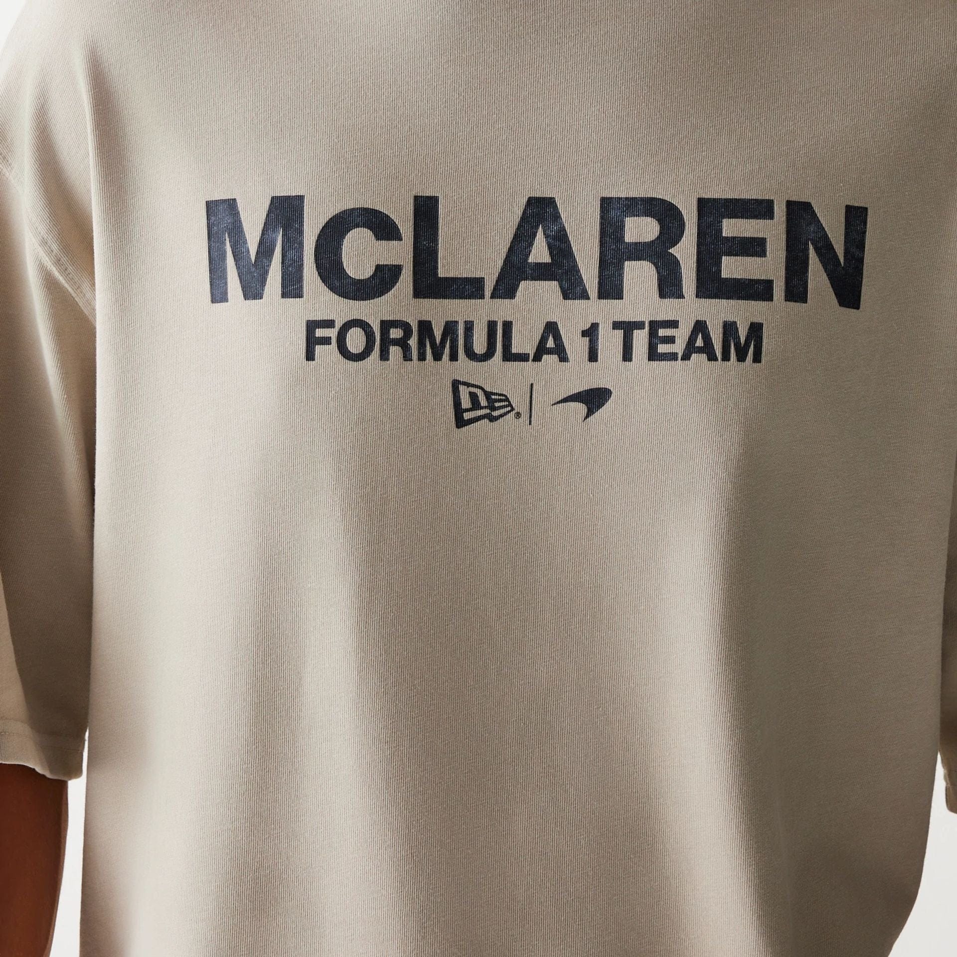 The Male model is wearing McLaren Racing Wordmark Light Beige Oversized T-Shirt 4