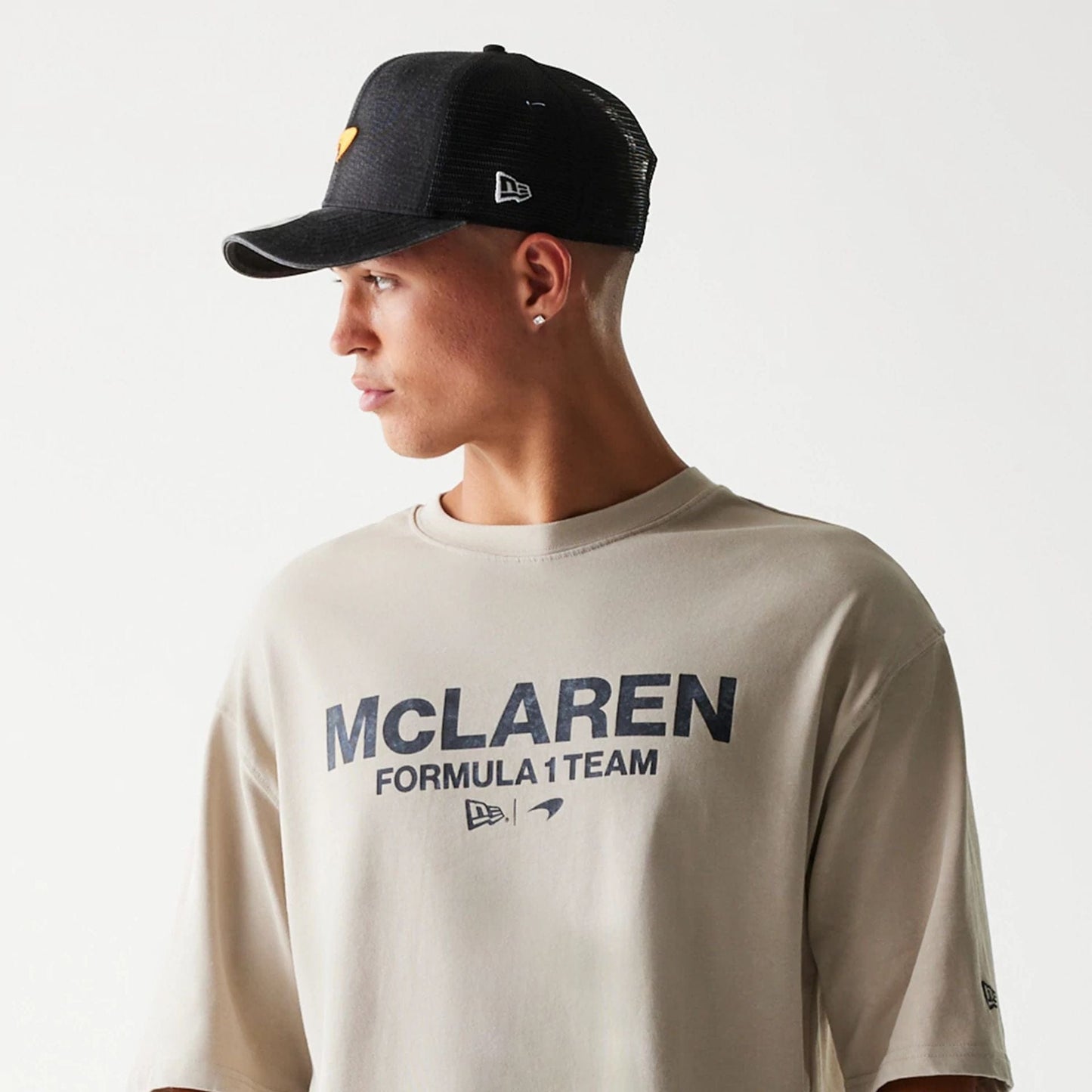 The Male model is wearing McLaren Racing Wordmark Light Beige Oversized T-Shirt 5