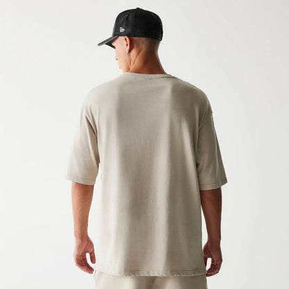 The Male model is wearing McLaren Racing Wordmark Light Beige Oversized T-Shirt 2