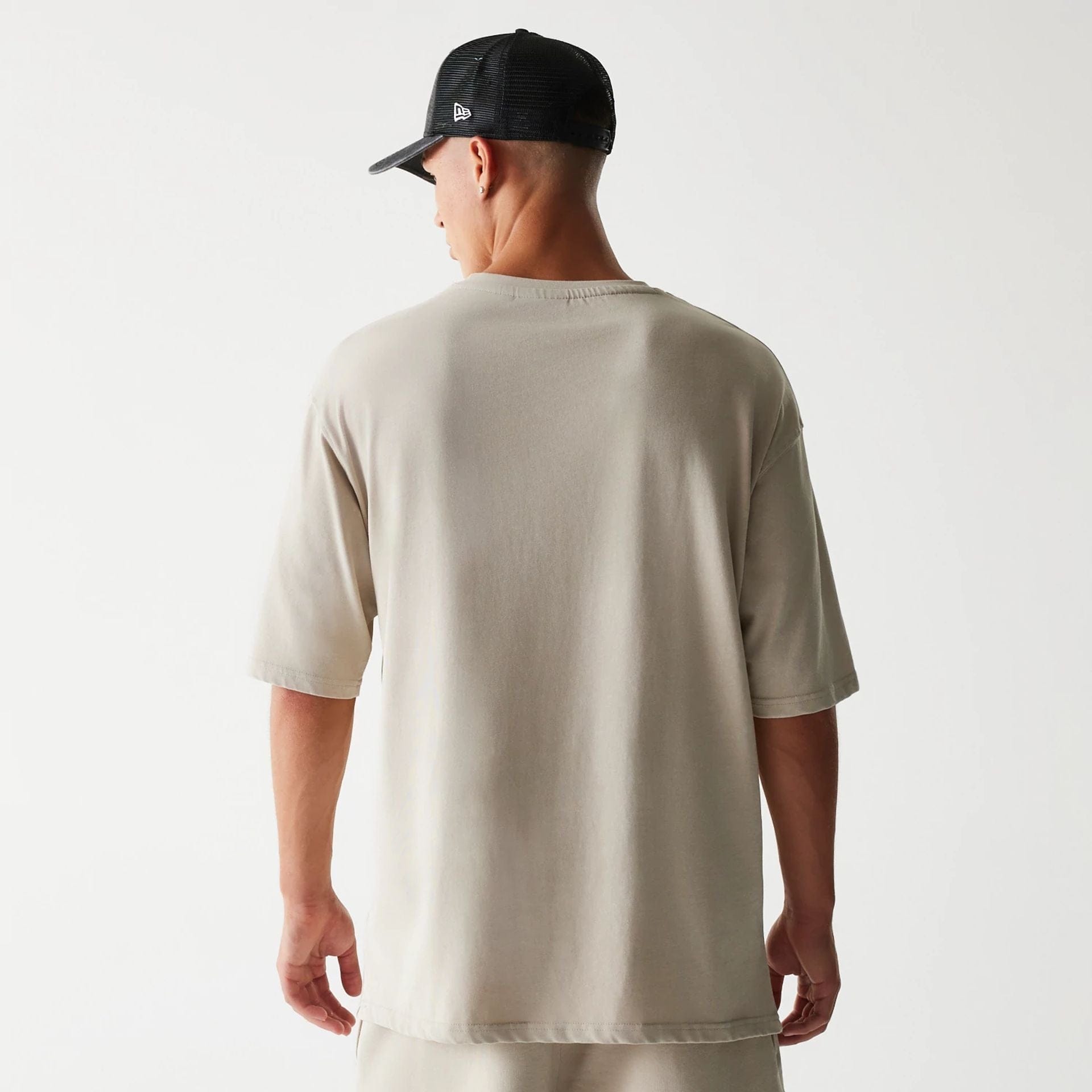 The Male model is wearing McLaren Racing Wordmark Light Beige Oversized T-Shirt 2