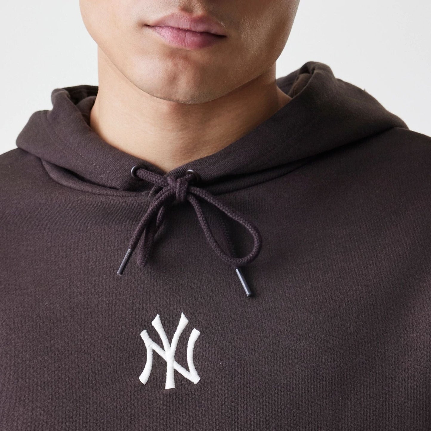 The Male model is wearing New York Yankees MLB Midi League Essential Dark Brown Oversized Pullover Hoodie  3