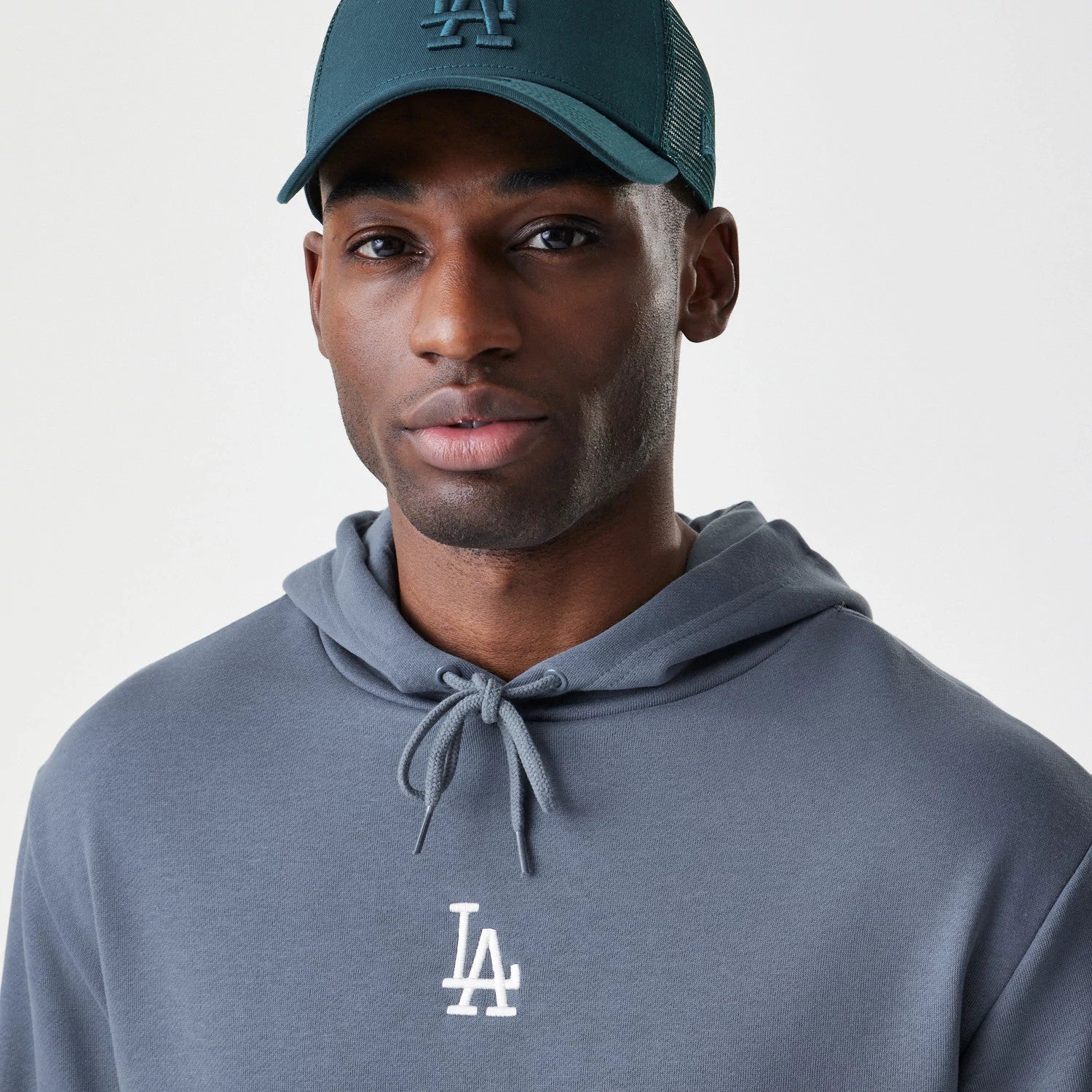 The Male model is wearing LA Dodgers MLB Midi League Essential Dark Grey Oversized Pullover Hoodie 4