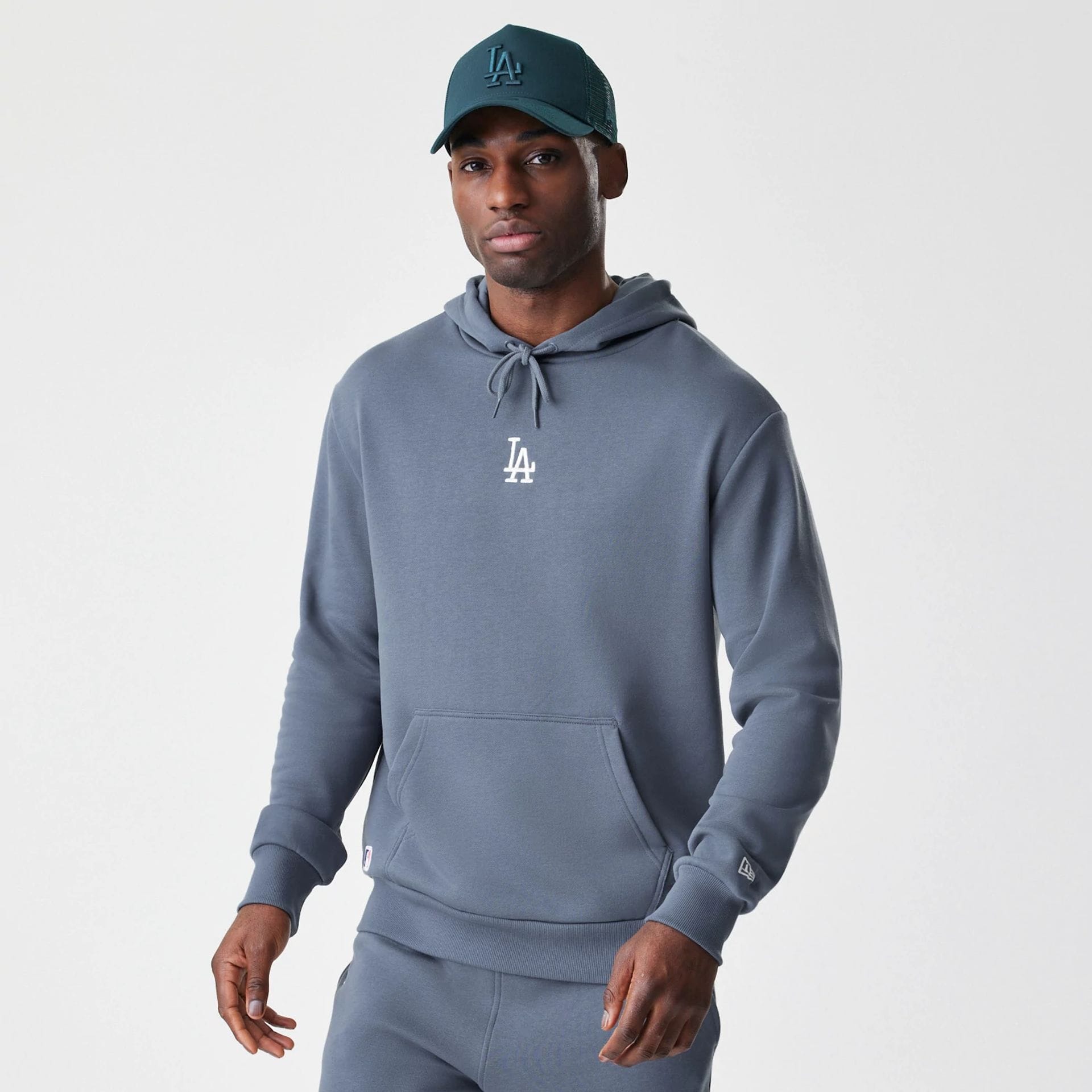 The Male model is wearing LA Dodgers MLB Midi League Essential Dark Grey Oversized Pullover Hoodie  1