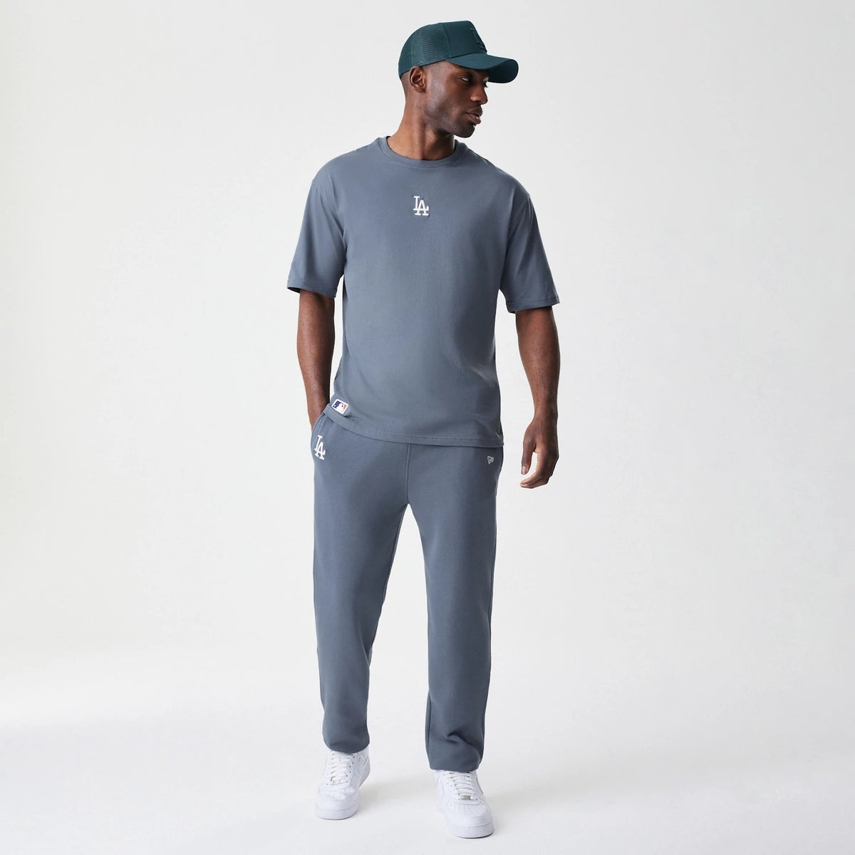 The Male model is wearing LA Dodgers MLB Midi League Essential Dark Grey Joggers 8
