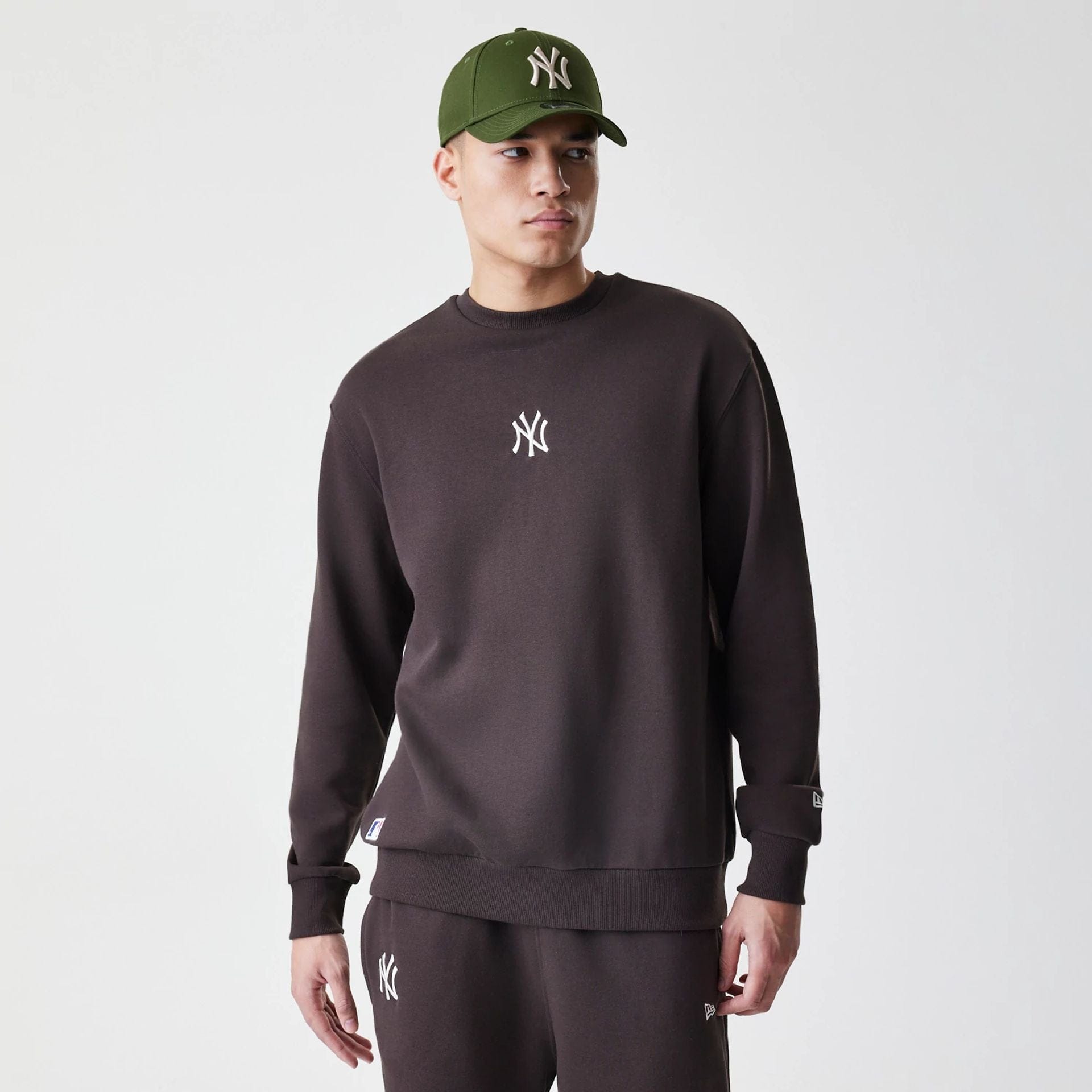 The Male model is wearing New York Yankees MLB Midi League Essential Dark Brown Oversized Crew Neck Sweater  1