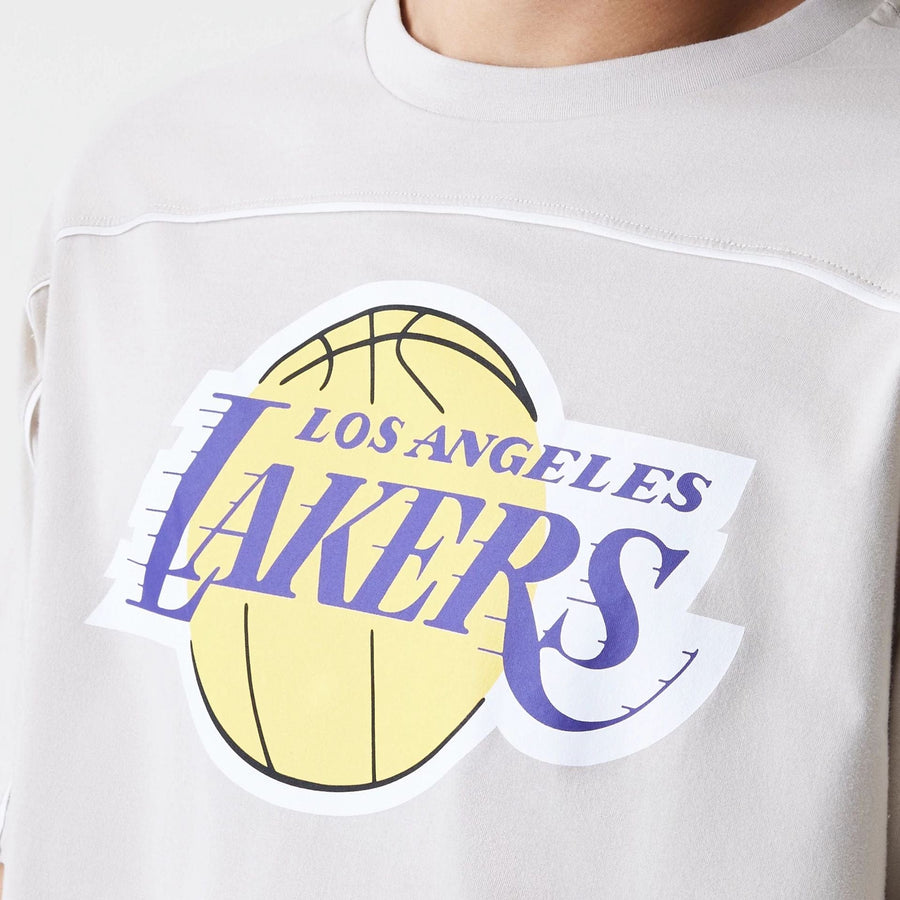 The Male model is wearing LA Lakers NBA Piping Light Beige Oversized T-Shirt  3
