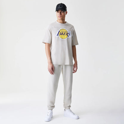 The Male model is wearing LA Lakers NBA Piping Light Beige Oversized T-Shirt  8