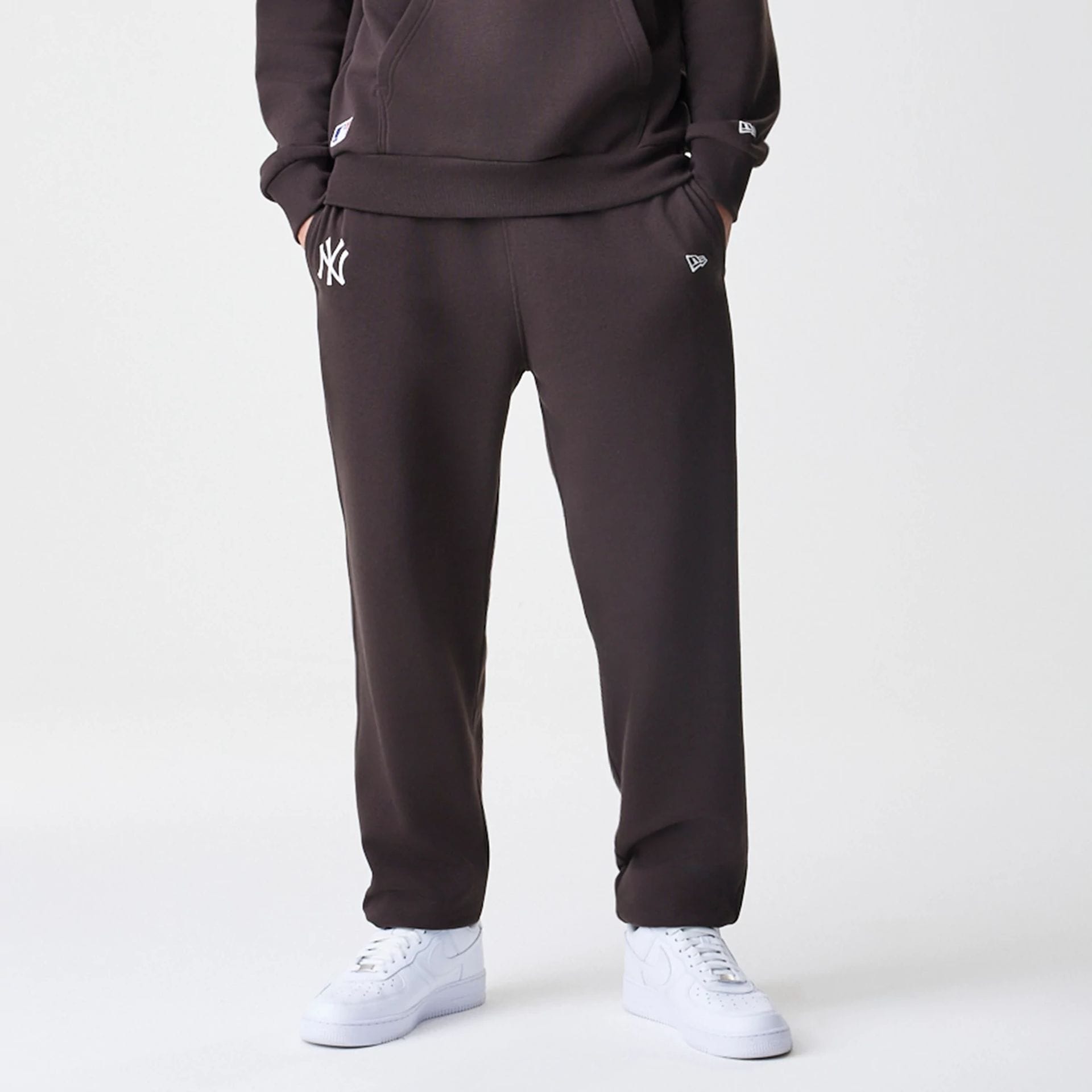 The Male model is wearing New York Yankees MLB Midi League Essential Dark Brown Joggers  7