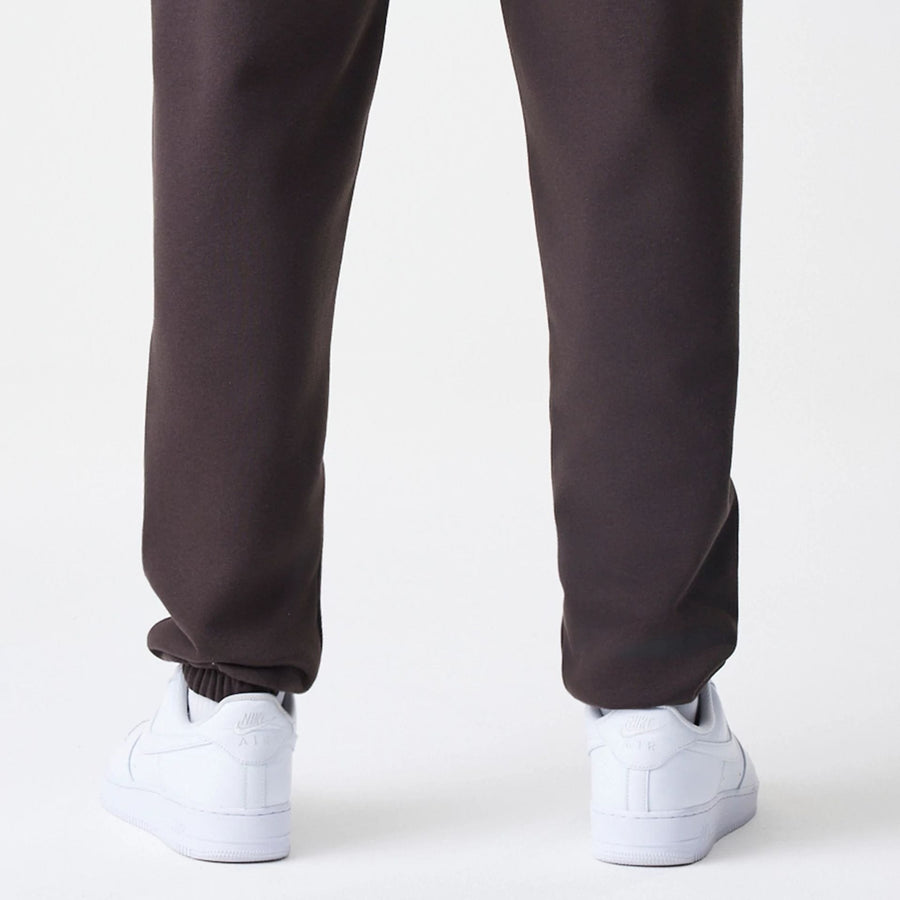 The Male model is wearing New York Yankees MLB Midi League Essential Dark Brown Joggers  4