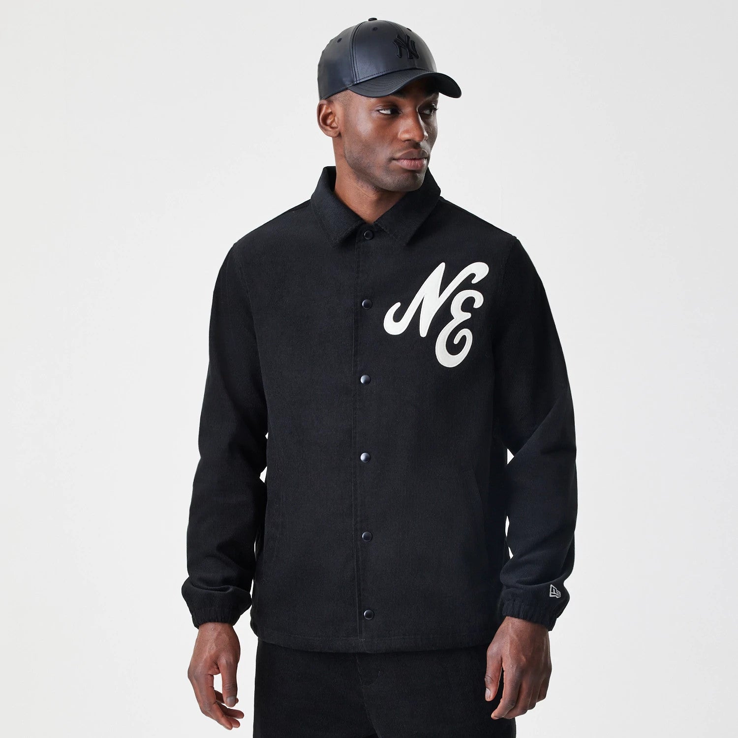 The Male model is wearing  New Era Cord Black Coaches Jacket 3