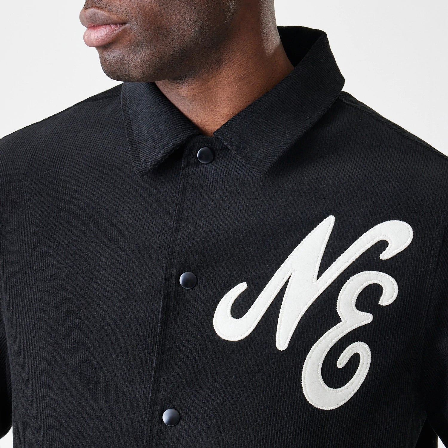 The Male model is wearing  New Era Cord Black Coaches Jacket 6