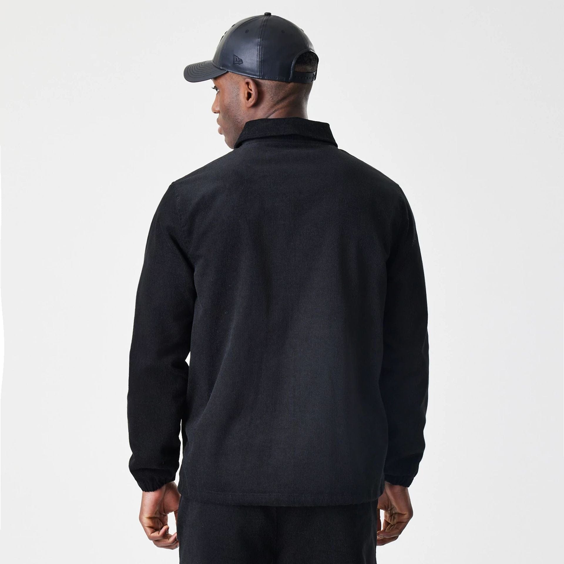 The Male model is wearing New Era Cord Black Coaches Jacket 2