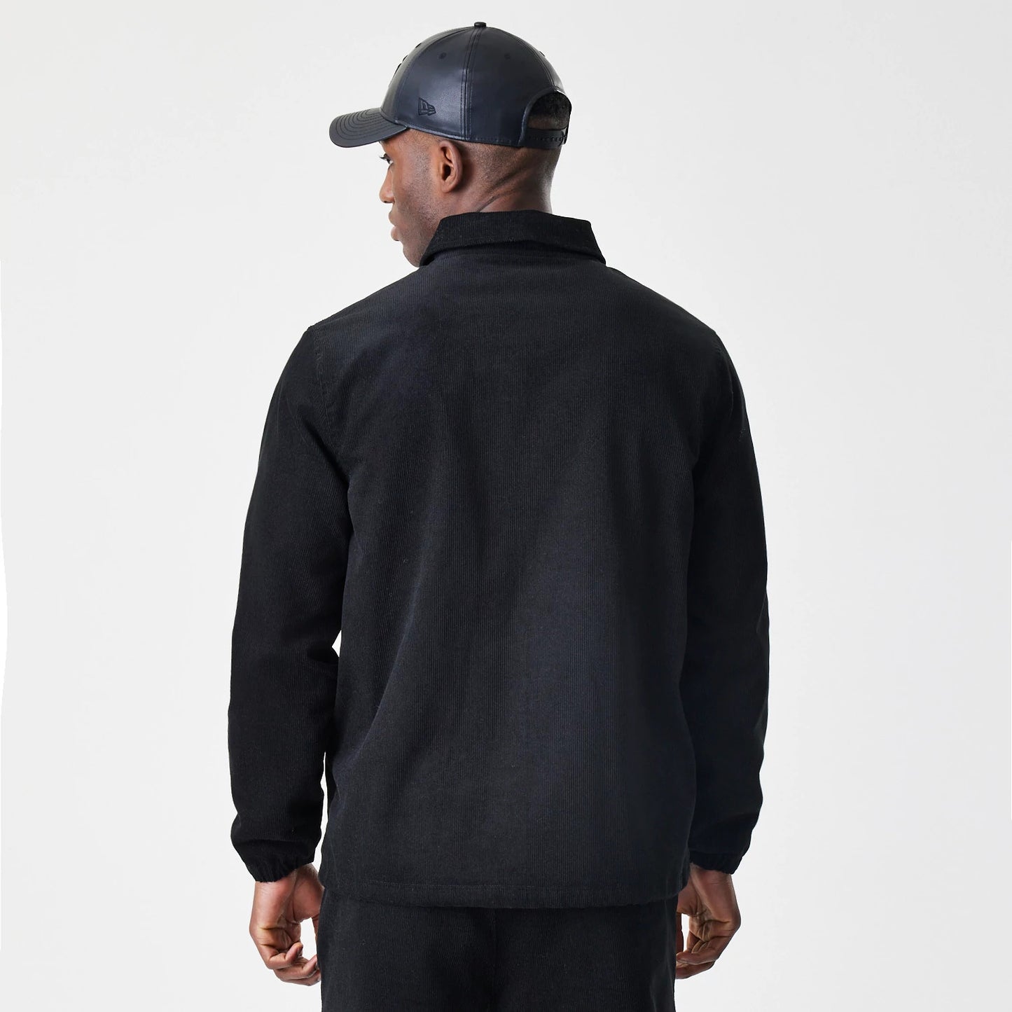 The Male model is wearing  New Era Cord Black Coaches Jacket 2