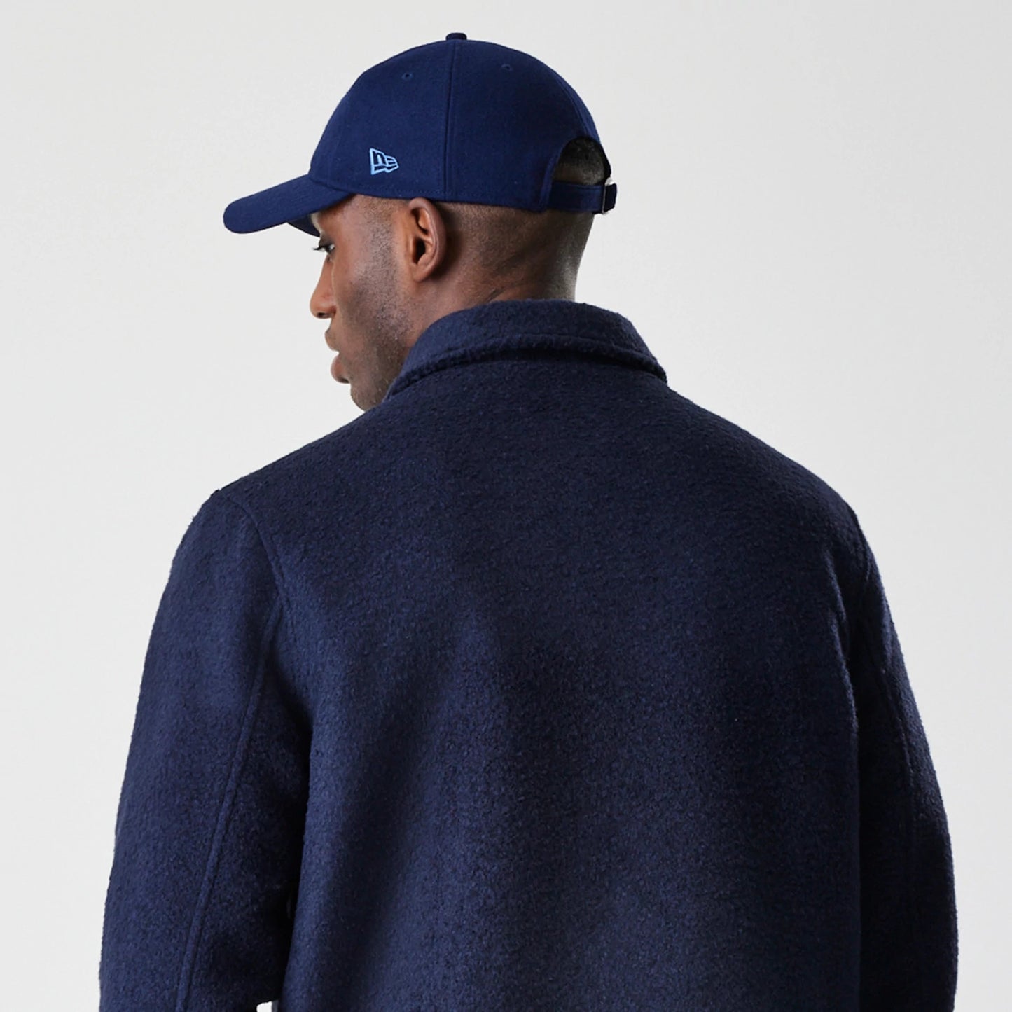 The Male model is wearing  New Era Borg Navy Shacket 7