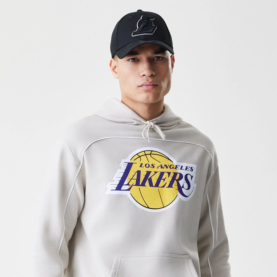 The Male model is wearing LA Lakers NBA Piping Cream Oversized Pullover Hoodie  6